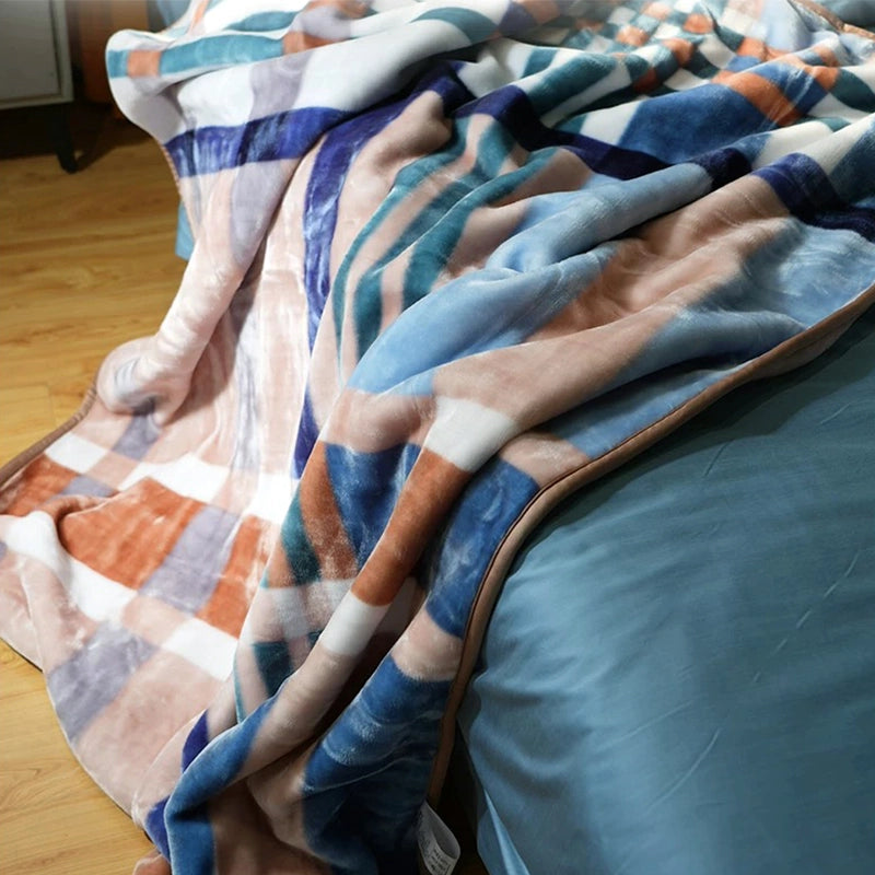 Sincdoo PLA blanket draped on bed, showcasing its soft and comfortable texture.