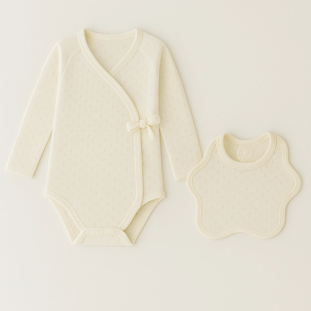 Beige PLA baby romper with matching bib, eco-friendly and microplastic-free for infant skin.